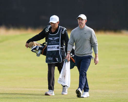 NORTH BERWICK, SCOTLAND - JULY 12: Rory McIlroy and his caddie Harry Diamond walk up the eighteenth fairway during the delayed Round 3 of the Genesis Scottish Open at the Renaissance Club, North Berwick on July 12, 2026 in North Berwick, Scotland Genesis Scottish Open Round 3
