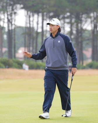 NORTH BERWICK, SCOTLAND - JULY 12: Min Woo Lee salutes the fans after holing a birdie putt on the 11th green during the delayed Round 3 of the Genesis Scottish Open at the Renaissance Club, North Berwick on July 12, 2026 in North Berwick, Scotland Genesis Scottish Open Round 3