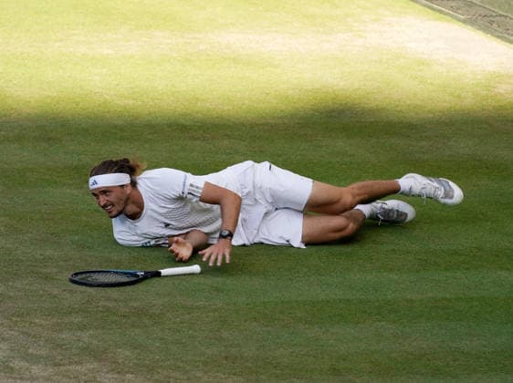 Tennis - 2026 Wimbledon Championships - Day Eleven (Week Two) - All England Lawn Tennis & Croquet Club, London - Sunday 12th July 2026 Centre Court - Mens singles Final Jannik Sinner (ITA) v Alexander Zverev (GER) Alexander Zverev (GER) slips on the grass COLORSPORT ANDREW COWIE 