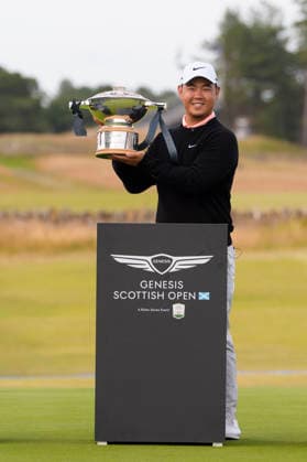 NORTH BERWICK, SCOTLAND - JULY 12: Tom Kim lifts the trophy on the 18th green after winning the Genesis Scottish Open at the Renaissance Club, North Berwick on July 12, 2026 in North Berwick, Scotland Genesis Scottish Open Round 4