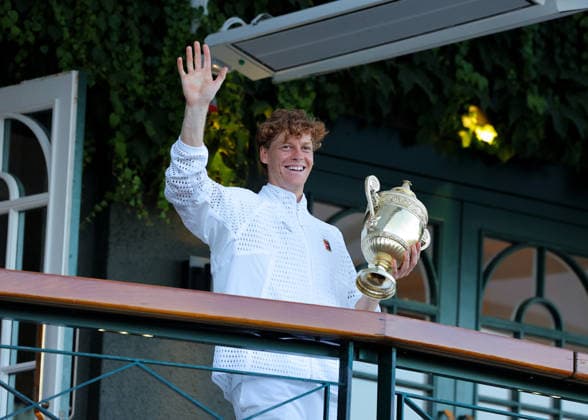RECORD DATE NOT STATED 12th July 2026; All England Lawn Tennis and Croquet Club, London, England; Wimbledon Tennis Tournament, Final Day; Jannik Sinner (ITA) waving to the crowd from the Centre Court balcony with the Gentlemens Singles Trophy for the 2nd time back to back after defeating Alexander Zverev (GER) JohnxPatrickxFletcher