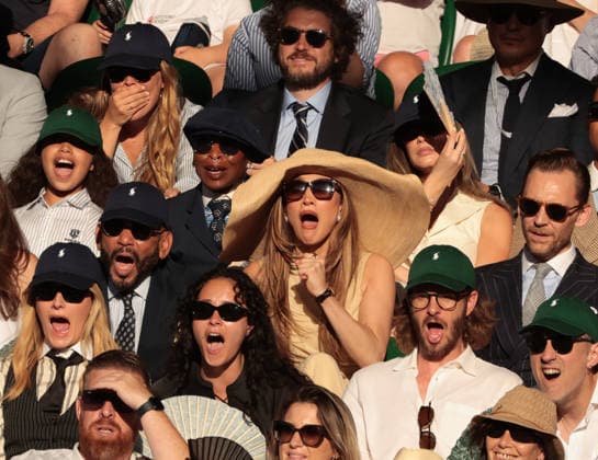 American actress Jennifer Lopez (C) and British actor Tom Hiddleston watch the Men s Wimbledon Singles final on day Fourteen of the 2026 Wimbledon Championships in London on Sunday, July 12,2026. Sinner won the match 6-7 7-6 6-3 6-4.  LON2026071294 HUGOxPHILPOTT