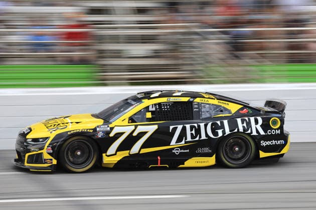 ATLANTA, GA - JULY 12: Carson Hocevar ( 77 Spire Motorsports Zeigler Auto Group Chevrolet) races into the tri-oval during the running of the NASCAR, Motorsport, USA Cup Series Quaker State 400 on July 12, 2026 at EchoPark Speedway in Hampton, GA. (Photo by Jeff Robinson Icon Sportswire) AUTO: JUL 12 NASCAR Cup Series Quaker State 400 EDITORIAL USE ONLY Icon26071213215400