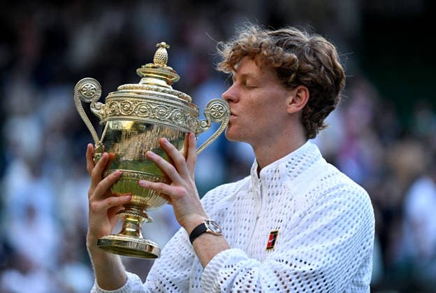 (260713) -- LONDON, July 13, 2026 -- Jannik Sinner of Italy kisses his trophy after winning the men s singles final against Alexander Zverev of Germany at the Wimbledon Tennis Championships in London, Britain, July 12, 2026. ) (SP)BRITAIN-LONDON-TENNIS-WIMBLEDON-MEN S SINGLES LixYing 