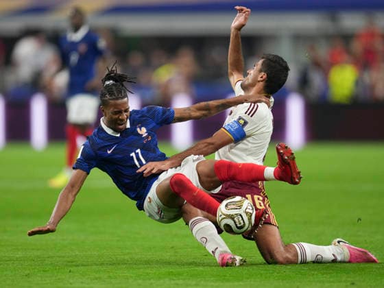 (260715) -- DALLAS, July 15, 2026 -- Michael Olise (L) of France falls down during the semifinal match between France and Spain at the 2026 FIFA World Cup, WM, Weltmeisterschaft, Fussball at Dallas Stadium in Dallas, the United States, July 14, 2026. ) (SP)U.S.-DALLAS-FOOTBALL-FIFA WORLD CUP-SEMIFINAL-FRA VS ESP WuxXiaoling 