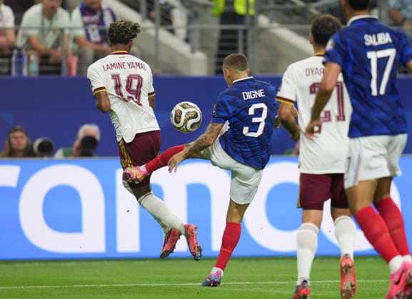 (260715) -- DALLAS, July 15, 2026 -- Lucas Digne (2nd L) of France fouls Lamine Yamal (1st L) of Spain during the semifinal match between France and Spain at the 2026 FIFA World Cup, WM, Weltmeisterschaft, Fussball at Dallas Stadium in Dallas, the United States, July 14, 2026. ) (SP)U.S.-DALLAS-FOOTBALL-FIFA WORLD CUP-SEMIFINAL-FRA VS ESP WuxXiaoling 