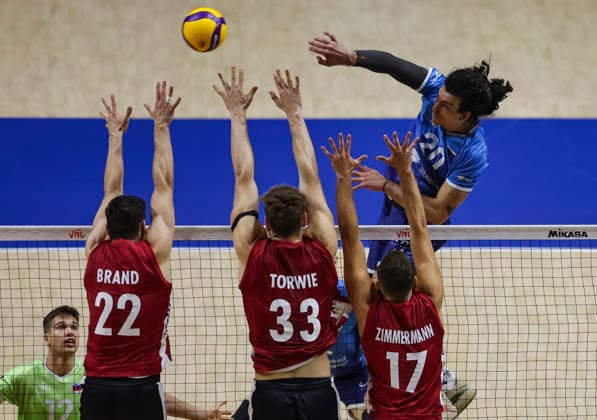 Men s Volleyball Nations League - Belgrade 2026 Slovenia s Nik Mujanovic spikes the ball against Germany s Tobias Brand, Germany s Simon Valentin Torwie and Germany s Jan Zimmermann during the MenÕs Volleyball Nations League Pool 7 match between Germany and Slovenia at Belgrade Arena on July 15, 2026 in Belgrade, Serbia. Belgrade Serbia Copyright: xSrdjanxStevanovicx x