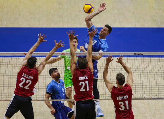 Men s Volleyball Nations League - Belgrade 2026 Slovenia s Jan Kozamernik spikes the ball against Germany s Tobias Brand, Germany s Tobias Krick and Germany s Yann Bohme during the MenÕs Volleyball Nations League Pool 7 match between Germany and Slovenia at Belgrade Arena on July 15, 2026 in Belgrade, Serbia. Belgrade Serbia Copyright: xSrdjanxStevanovicx x
