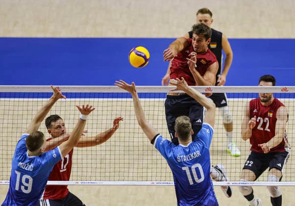 Men s Volleyball Nations League - Belgrade 2026 Germany s Tobias Krick spikes the ball against Slovenia s Saso Stalekar and Slovenia s Rok Mozic (L) during the MenÕs Volleyball Nations League Pool 7 match between Germany and Slovenia at Belgrade Arena on July 15, 2026 in Belgrade, Serbia. Belgrade Serbia Copyright: xSrdjanxStevanovicx x