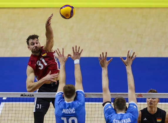 Men s Volleyball Nations League - Belgrade 2026 Germany s Yann Bohme spikes the ball against Slovenia s Rok Mozic and Slovenia s Saso Stalekar during the Men™s Volleyball Nations League Pool 7 match between Germany and Slovenia at Belgrade Arena on July 15, 2026 in Belgrade, Serbia. Belgrade Serbia Copyright: xSrdjanxStevanovicx x