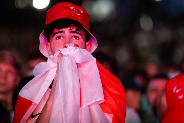 England Vs Argentina World Cup Semi Final in Manchester, UK - 15 JULY 2026. An England fan seen covering his mouth with a St. George s flag after England lost 2-1 to Argentina in the World Cup semi-final. The sold-out Castlefield Bowl, organised by The Road Victory, saw thousands of fans come together to watch England play Argentina in a World Cup battle for the first time since France 98. Manchester United, ManU Kingdom Copyright: xAndyxBartonx xSOPAxImagesx 0861772980st