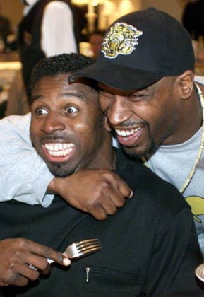 November 25, 1999, Vancouver, Bc, Canada: Toronto Argonauts great Mike (Pinball) Clemons is surprised by Hamilton Tiger-Cats Calvin Tiggle (right) during the Ticats players lunch in Vancouver on Thursday, Nov. 25, 1999. (CP PHOTO ) MIKE (PINBALL) CLEMONS-CALVIN TIGGLE  - ZUMAc35_ 19991125_zaf_c35_001 Copyright: xRyanxRemiorzx