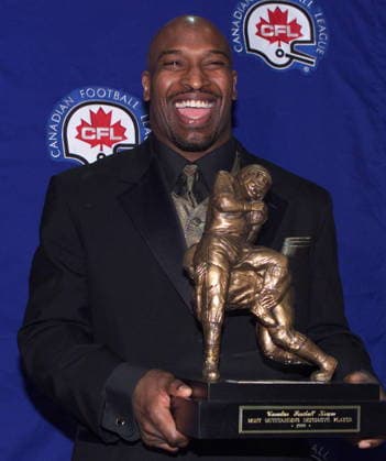 November 26, 1999, Vancouver, Bc, Canada: Hamilton Tiger-Cats linebacker Calvin Tiggle laughs as he holds his trophy after winning the Most Outstanding Defensive Player award at the CFL Outstanding Player Awards in Vancouver on Friday, November 26, 1999. (CP PHOTO ) TIGGLE  - ZUMAc35_ 19991126_zaf_c35_001 Copyright: xKevinxFrayerx