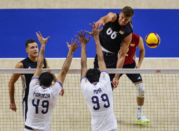 WomenÕs Volleyball Nations League - Belgrade 2026 Germany s Erik Rohrs spikes the ball against IranÕs Morteza Sharifi and IranÕs Mohammadnima Bateni during the MenÕs Volleyball Nations League Pool 7 match between Germany and Iran at Belgrade Arena on July 16, 2026 in Belgrade, Serbia. Belgrade Serbia Copyright: xSrdjanxStevanovicx x