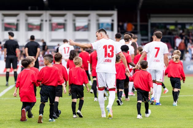 COLOGNE, GERMANY - JULY 18: Said El Mala (1. FC Koeln, 13) walking in with a crowd of mascots before the first friendly game of season 2026 27 between 1. FC Koeln vs FC Rheinsued Koeln at Suedstadion on July 18, 2026 in Cologne, Germany. North Rhine Westphalia Germany Copyright: xSteffiexWunderlx