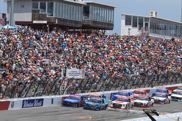 NORTH WILKESBORO, NC - JULY 18: Layne Riggs ( 34 Front Row Motorsports Infinite Communications Group Ford) and Carson Hocevar ( 77 Spire Motorsports Delaware Life Chevrolet) lead the field to the green flag during the running of the NASCAR, Motorsport, USA Craftsman Truck Series FaithFest 250 on July 18, 2026 at North Wilkesboro Speedway in North Wilkesboro, NC. (Photo by Jeff Robinson Icon Sportswire) AUTO: JUL 18 NASCAR CRAFTSMAN Truck Series Faith Fest 250 EDITORIAL USE ONLY Icon26071824579250