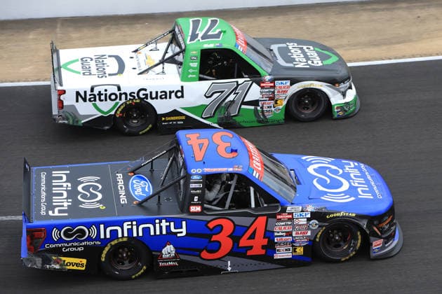 NORTH WILKESBORO, NC - JULY 18: Shane Van Gisbergen ( 71 Spire Motorsports NationsGuard Chevrolet) races with Layne Riggs ( 34 Front Row Motorsports Infinite Communications Group Ford) in turn 4 during the running of the NASCAR, Motorsport, USA Craftsman Truck Series FaithFest 250 on July 18, 2026 at North Wilkesboro Speedway in North Wilkesboro, NC. (Photo by Jeff Robinson Icon Sportswire) AUTO: JUL 18 NASCAR CRAFTSMAN Truck Series Faith Fest 250 EDITORIAL USE ONLY Icon26071825169250