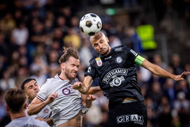 STURM GRAZ - HEARTS Jon Gorenc Stankovic of Sturm scores a goal and Christian Borchgrevink of Hearts during the first leg of second qualifying round of UEFA Champions League football match between Sturm Graz and Heart of Midlothian FC at the Merkur Arena (Stadion Graz Liebenau). Graz, Austria, July 21, 2026. Photo by Branislav Racko Copyright: xx 080A1304