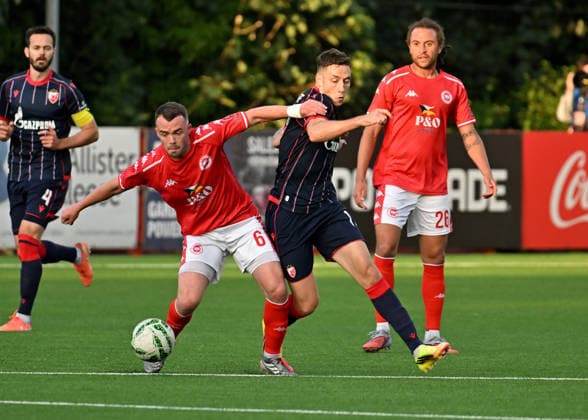 UEFA Champions League Second Qualifying Round First Leg, Inver Park, Belfast, Northern Ireland 21 7 2026 Larne vs Crvena Zvezda Larnes Chris Gallagher with Crvena Zvezda™s Bruno Duarte Chris Gallagher with Bruno Duarte 21 7 2026  Copyright: xx Larne v Crvena Zvezda-023