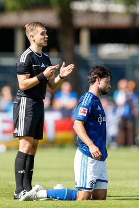 SOCCER - Schalke vs Kharkiv, test match KEMATEN,AUSTRIA,22.JUL.26 - SOCCER - 1. DFL, 1. Deutsche Bundesliga, Premjer-Liha, FC Schalke 04 vs FC Kharkiv, test match. Image shows referee Daniel Pfister and Adrian Gantenbein (Schalke).  GEPAxpictures xMarkoxVulic
