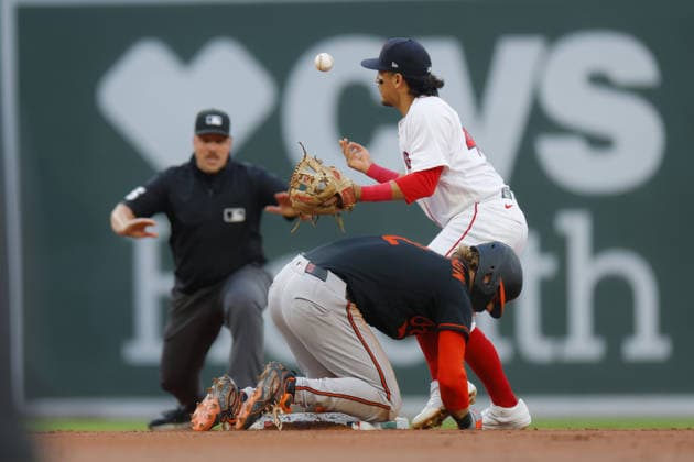Boston Red Sox second baseman Anthony Seigler bobbles the ball as Baltimore Orioles Gunnar Henderson is safe at second base during the first inning at Fenway Park in Boston, Massachusetts on Wednesday, July 22, 2026.  BOP20260722005 CJxGUNTHER