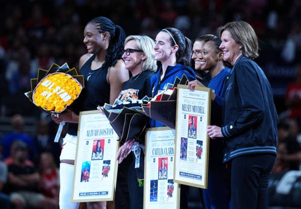 INDIANAPOLIS, IN - JULY 22: From left to right Indiana Fever center Aliyah Boston (7) and COO & General Manager Amber Cox and guard Caitlin Clark (22) and head coach Stephanie White and guard Kelsey Mitchell (0) and President of Basketball & Business Operations Kelly Krauskopf pose for a photo at center court as the players are honored for being selected as starters for the 2026 WNBA, Basketball Damen, USA All Star Game before the game against the Connecticut Sun on July 22, 2026, at Gainbridge Fieldhouse in Indianapolis, Indiana. (Photo by Brian Spurlock Icon Sportswire) WNBA: JUL 22 Connecticut Sun at Indiana Fever EDITORIAL USE ONLY Icon26072241