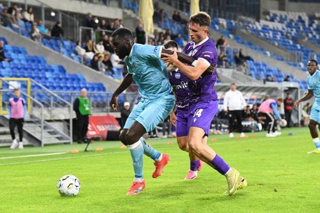 Gent s Wilfried Kanga and Cherkasy s Oleksandr Drambaiev pictured in action during a soccer game between Ukrainian FC LNZ Cherkasy and Belgian KAA Gent, Thursday 23 July 2026 in Plock, Poland, the first leg of the second qualifying round for the UEFA Conference League. JILLxDELSAUX  x181870817x