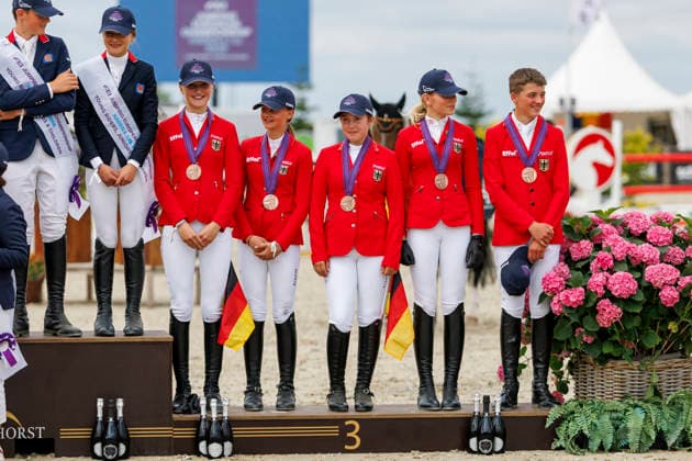 HAGEN a.T.W. - FEI Jumping European Championship, EM, Europameisterschaft Children, Juniors and Young Rider 2026, HAGEN a.T.W. - FEI Jumping European Championship Children, Juniors and Young Rider 2026 Team Germany KUEHNER Grace Isabelle (GER), OSING Mila (GER), THOMSEN Justus (GER), BROCKS Luisa Charlotte (GER), SPREHE Joelle (GER), (SEEMANN Eberhard) Championship ceremony Team Final Nations Cup CH-EU-Ch-S - Children 2nd COMPETITION Teams & Individuals over two rounds - SECOND ROUND Hagen a.T.W., Reitanlage Haunhorst 24. July 2026 - *** HAGEN a T W FEI Jumping European Championship for Children, Juniors, and Young Riders 2026, HAGEN a T W FEI Jumping European Championship for Children, Juniors, and Young Riders 2026 Team Germany KUEHNER Grace Isabelle GER, OSING Mila GER, THOMSEN Justus GER, BROCKS Luisa Charlotte GER, SPREHE Joelle GER, SEEMANN Eberhard Championship Ceremony Team Final Nations Cup CH EU Ch S Children 2nd COMPETITION Teams Individuals over two rounds SECOND ROUND Hagen a T W, Haunhorst Equestrian Center, July 24, 2026