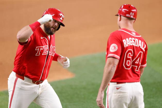 July 24, 2026, Arlington, Texas, USA: Texas Rangers first baseman JAKE BURGER (21) celebrates a home run in the fourth inning with Texas Rangers third base coach COREY RAGSDALE (64) In a baseball game, Friday, July 24, 2026, in Arlington, Texas. Arlington USA - ZUMAa325 20260724_zsa_a325_008 Copyright: xDavidxBalleringxIix