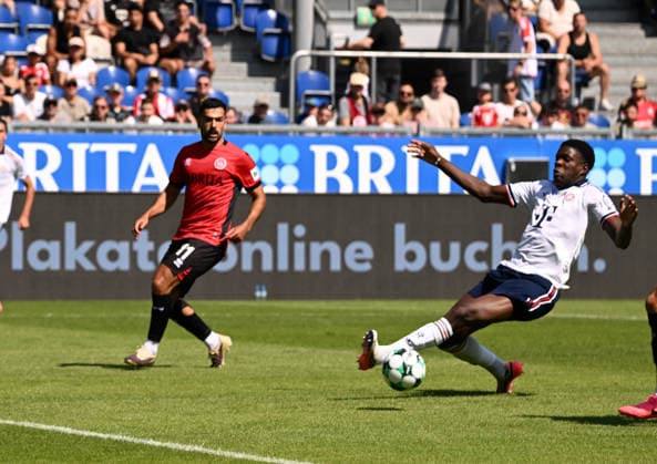 25.07.2026, xsltx, Fussball Testspiel, SV Wehen Wiesbaden - FC Bayern München v.l. Tarik Gözüsirin (SV Wehen Wiesbaden), Bastian Assomo (FC Bayern München) (DFL DFB REGULATIONS PROHIBIT ANY USE OF PHOTOGRAPHS as IMAGE SEQUENCES and or QUASI-VIDEO) *** July 25, 2026, xsltx, soccer friendly match, SV Wehen Wiesbaden vs. FC Bayern Munich, Tarik Gözüsirin (SV Wehen Wiesbaden), Bastian Assomo (FC Bayern Munich). DFL and DFB regulations prohibit any use of photographs as image sequences and or quasi-video.