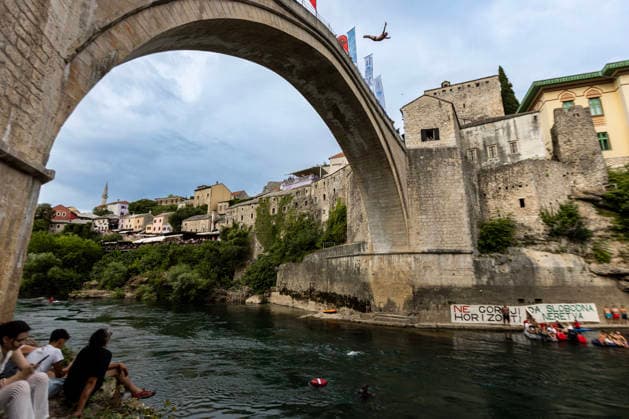 Mostar Old Bridge Diving Competition A participant dives from historical Old Bridge , also known as Mostar Bridge during the traditional diving competition event, 460th Traditional Mostar Old Bridge Diving Competition, in Mostar, Bosnia and Herzegovina on July 26, 2026. Each year, thousands of spectators watch the event across the Old Bridge that crosses Neretva river.  DenisxKapetanovic PIXSELL