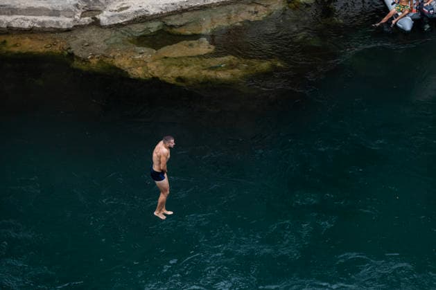 Mostar Old Bridge Diving Competition A participant dives from historical Old Bridge , also known as Mostar Bridge during the traditional diving competition event, 460th Traditional Mostar Old Bridge Diving Competition, in Mostar, Bosnia and Herzegovina on July 26, 2026. Each year, thousands of spectators watch the event across the Old Bridge that crosses Neretva river.  DenisxKapetanovic PIXSELL
