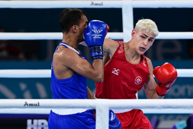 COM26 BOXING, Jye Dixon (red) of Australia in action during his Quarter Final match against Md Rakib Hossain (blue) of Bangladesh during the Glasgow 2026 Commonwealth Games at SEC Centre in Glasgow, United Kingdom, Tuesday, July 28, 2026. ( NO ARCHIVING, EDITORIAL USE ONLY, AUSTRALIA ONLY Glasgow Scotland United Kingdom  Copyright: xDEANxLEWEINSx 20260728172558585778