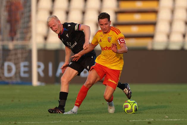 Como, Italy, 28th July 2026. Florian Thauvin of Racing Club de Lens takes on Will Hughes of Crystal Palace FC during the Crystal Palace vs Racing Club de Lens Pre Season Friendly match at Stadio Giuseppe Sinigaglia, Como. Picture credit should read: Jonathan Moscrop Sportimage EDITORIAL USE ONLY. No use with unauthorised audio, video, data, fixture lists, club league logos or live services. Online in-match use limited to 120 images, no video emulation. No use in betting, games or single club league player publications. SPI_023_JM_PALACE_LENS SPI-4866-0022