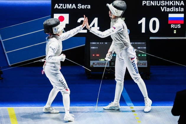 CHINA, HONG KONG - JULY 30, 2026: Athletes Vladislava Peniushkina (R) of Russia and Sera Azuma of Japan high-five in their team foil bout during the 2026 Kerry Fencing World Championships. Mikhail Sinitsyn TASS  95619638