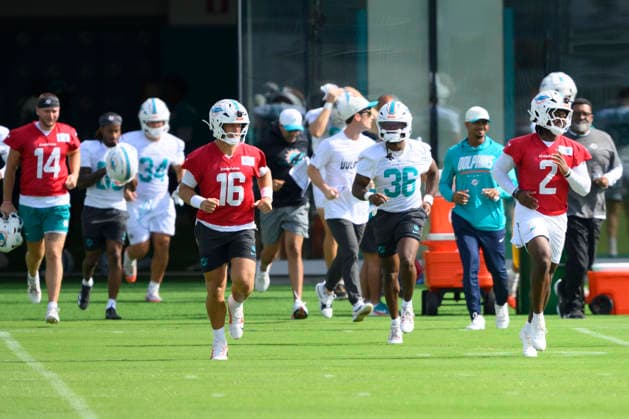 MIAMI GARDENS, FL - JULY 30: Miami Dolphins quarterback Malik Willis (2), running back Donovan Edwards (36) and quarterback Mark Gronowski (16) run onto the field during the Miami Dolphins Training Camp on July 30, 2026, at the Baptist Health Training Complex in Miami Gardens, FL. (Photo by Doug Murray Icon Sportswire) NFL, American Football Herren, USA JUL 30 Dolphins Training Camp EDITORIAL USE ONLY Icon796260730010