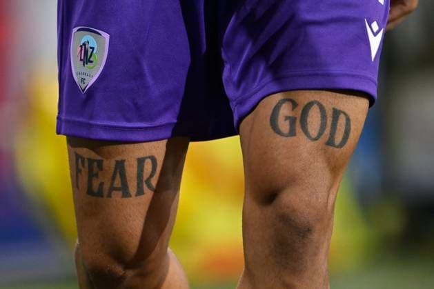 Sport Bilder des Tages KAA Gent v LNZ Cherkasy - UEFA Conference League GENT, BELGIUM - JULY 30 : Illustration picture showing a Tattoo of Fear God on the legs of Cara Tedi midfielder of LNZ Cherkasy during the UEFA Conference League 2026 27 second qualifying round second leg between KAA Gent and LNZ Cherkasy on July 30, 2026 in Gent, Belgium, 30 07 2026 Gent Belgium  Copyright: xNicoxVereeckenx