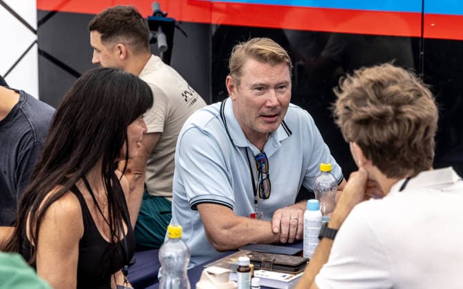 Former Finnish race car driver and Formula 1 pilot Mika Hakkinen (center) and his wife Marketa (left) at the pit area in Most, where their daughter Ella will be competing in a formula 4 race, on August 1, 2026. Snapshots from the afternoon before the race. (CTKxPhoto VojtechxHajek) CTKPhotoF202608010000301  CTKPhotoF202608010000301