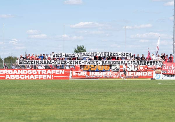 Fußball Regionalliga Staffel West 1. Spieltag SV Westfalia Rhynern - Sportfreunde Siegen am 01.08.2026 im Kümpel + Hellmeister Arena im Westfalia Sportpark in Hamm-Rhynern Spruchband der Fans von Sportfreunde Siegen bzgl. Regionalligareform *** Soccer Regional League, West Division 1, Matchday: SV Westfalia Rhynern vs. Sportfreunde Siegen on August 1, 2026, at the Kümpel Hellmeister Arena in the Westfalia Sportpark in Hamm-Rhynern. Banner displayed by Sportfreunde Siegen fans regarding Regional League reform xMAx