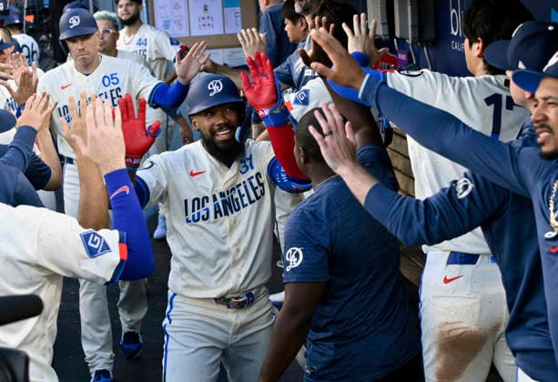 Los Angeles Dodger right fielder Teoscar Hernandez celebrates with teammates in the dugout after hitting a two-run homer in the second inning at Dodger Stadium in Los Angeles on Saturday, August 1, 2026.  LAP2026080110 JIMxRUYMEN