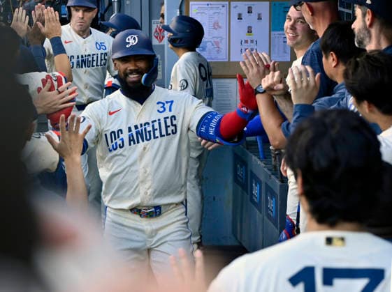 Los Angeles Dodger right fielder Teoscar Hernandez celebrates with teammates in the dugout after hitting a two-run homer in the second inning at Dodger Stadium in Los Angeles on Saturday, August 1, 2026.  LAP2026080111 JIMxRUYMEN