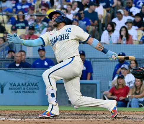 Los Angeles Dodgers shortstop Miguel Rojas grimaces after hitting the ball off his leg in the fourth inning at Dodger Stadium against the Boston Red Sox in Los Angeles on Saturday, August 1, 2026.  LAP2026080116 JIMxRUYMEN