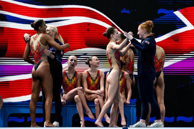 Athletes of team Great Britain react after competing in the artistic swimming Team Free Final with the coaches during the European Aquatics Championships at the Olympic Aquatic Center in Paris (France), August 3, 2026. Andrea Staccioli