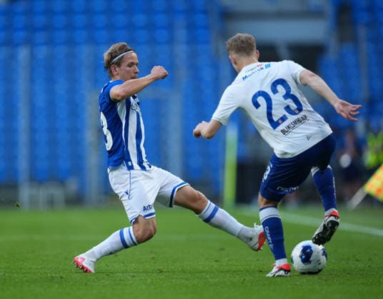 Antoni Kozubal of Lech Poznan tackles Joannes Danielsen of KI Klaksvik during UEFA Conference League - Third Qualifying Round season 26 27 match between teams of Lech Poznan and KI Klaksvik (Ruslan Taran Ball Raw Images) Poznan Enea Stadion Poland Copyright: xRuslanxTaranx RUS_LPOvKLA-0054