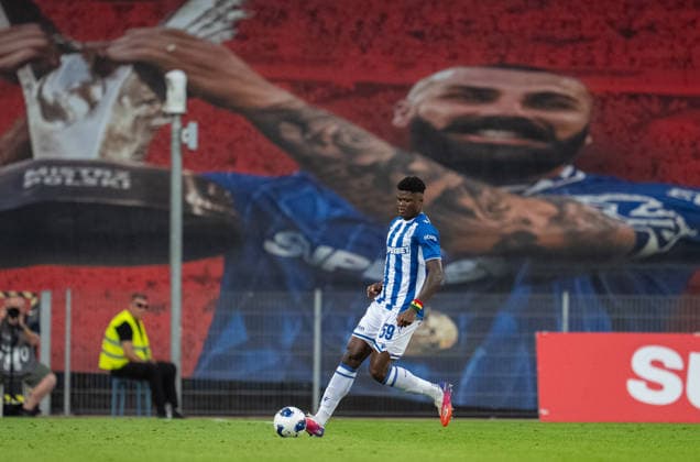 Terry Yegbe of Lech Poznan runs with the ball, Mikael Ishak poster in the background during UEFA Conference League - Third Qualifying Round season 26 27 match between teams of Lech Poznan and KI Klaksvik (Ruslan Taran Ball Raw Images) Poznan Enea Stadion Poland Copyright: xRuslanxTaranx RUS_LPOvKLA-0130