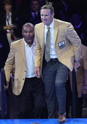 The 2026 Pro Football Hall of Fame Class members Roger Craig (L) and Drew Brees walk onto the stage after receiving their Gold Jacket at a ceremony Ceremony in Canton, Ohio, on Friday, August 7, 2026.  CAN20260807131 AARONxJOSEFCZYK