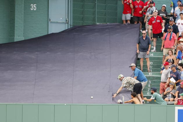 Fans reach for the home run ball hit by Athletics Henry Bolte during the ninth inning against the Boston Red Sox at Fenway Park in Boston, Massachusetts on Saturday, August 8, 2026.  BOP2026080819 CJxGUNTHER