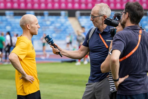 BIRMINGHAM, GREAT BRITAIN - AUGUST 9, 2026 : Florian BREMM (GER Germany) interviewed by Ralf Scholt (ARD) during the training day before the European Athletics Championships at Alexander Stadium on August 9, 2026 in Birmingham, Great Britain. Nordrhein-Westfalen Great Britain Copyright: xLeahxKohringx