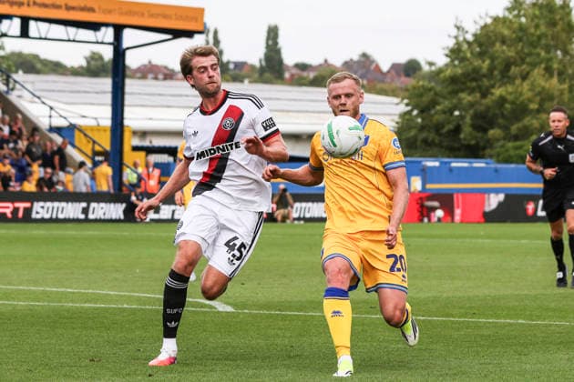 Mansfield Town v Sheffield United, Carabao Cup Frazer Blake-Tracy of Mansfield Town and Patrick Bamford of Sheffield United battle for the ball during the Mansfield Town v Sheffield United Carabao Cup 1st Round match at Field Mill One Call Stadium, Mansfield, England on 9 August 2026 Credit: Richard Bierton Every Second Media Editorial use only. All images are copyright Every Second Media Limited. No images may be reproduced without prior permission. All rights reserved. Premier League and Football League images are subject to licensing agreements with Football DataCo Limited. see https: www.football-dataco.com Copyright: xIMAGO EveryxSecondxMediax ESM-2086-0031 RichardxBiertonx xEveryxSecondxMediax