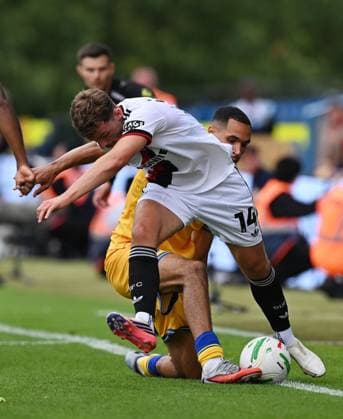 Harrison Burrows of Sheffield United is tackled by Jon Russell of Mansfield Town Mansfield Town v Sheffield United, EFL Carabao Cup, First Round, Football, One Call Stadium, Mansfield, UK - 09 Aug 2026Mansfield One Call Stadium United Kingdom EDITORIAL USE ONLY No use with unauthorised audio, video, data, fixture lists, club league logos or live services. Online in-match use limited to 120 images, no video emulation. No use in betting, games or single club league player publications.  Copyright: xAnnaxGowthorpe Shutterstockx 17051191ck